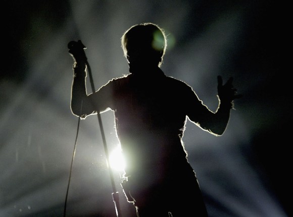 MANCHESTER, ENGLAND - NOVEMBER 17: David Bowie in silhouette performs on the first night of his UK tour at the MEN Arena on November 17, 2003 in Manchester, England. (Photo by Alex Livesey/Getty Images)